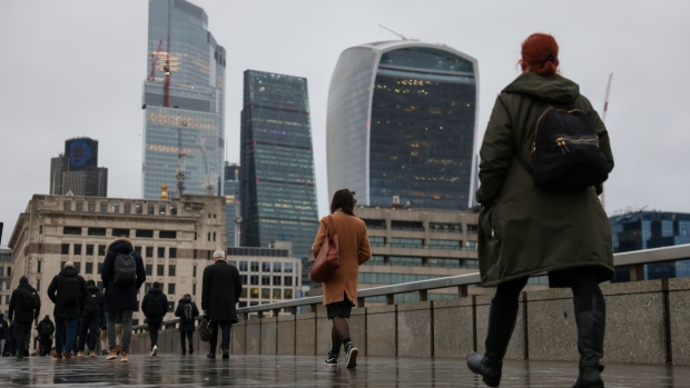 Commuters cross London Bridge in the City of London, UK, on Tuesday, March 21, 2023. The UK labor market showed some signs of cooling as wage growth slowed for the first time in more than a year. Photographer: Hollie Adams/Bloomberg