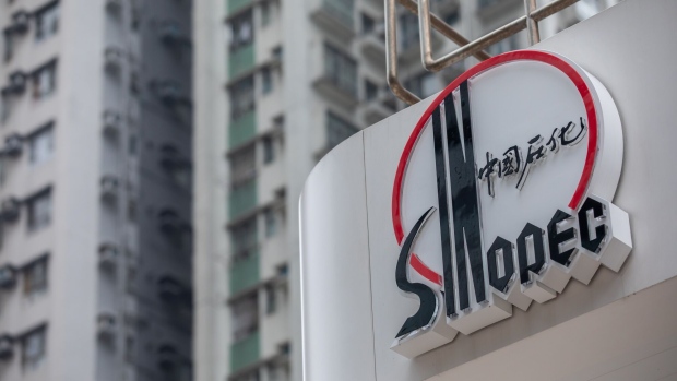 The logo for China Petroleum & Chemical Corp. (Sinopec) at a gas station in Hong Kong, China, on Saturday, March 25, 2023. Sinopec earnings fell last year as Covid restrictions pinched fuel demand, while domestic output of oil and gas rose to a record level. Photographer: Paul Yeung/Bloomberg