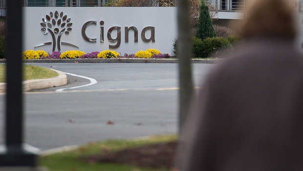 Pedestrians walk towards Cigna Corp. headquarters in Bloomfield, Connecticut. Photographer: Michael Nagle/Bloomberg