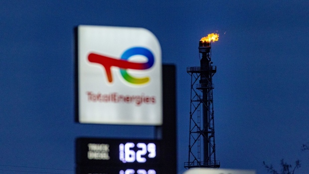 Fire burns from a flare stack at the PCK Schwedt oil refinery, formerly owned by Rosneft PJSC and now controlled by the German government, beyond a TotalEnergies SE gas station in Schwedt, Germany, on Monday, March 20, 2023. Germany's economy will probably shrink in the first quarter of the year, according to the ZEW institute's gauge of expectations, as concerns over risks in the banking sector add to headwinds from inflation, even as the rate should decline "significantly", the Bundesbank said. Photographer: Krisztian Bocsi/Bloomberg