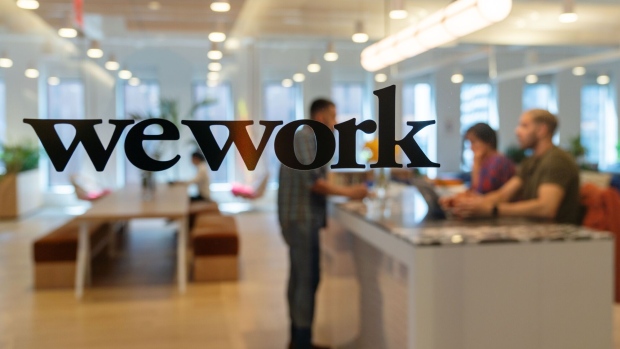 Signage is seen at the entrance of the WeWork Cos Inc. 85 Broad Street offices in the Manhattan borough of New York, U.S., on Wednesday, May 22, 2019. WeWork has become the biggest private office tenant in London, Manhattan and Washington on its way to 425 office locations in 36 countries overall. Photographer: David 'Dee' Delgado/Bloomberg