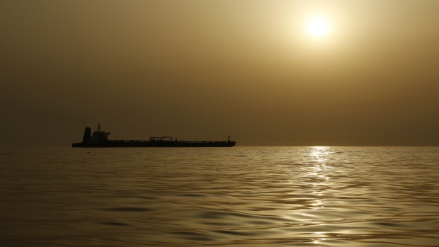 The impounded Iranian crude oil tanker, Grace 1, is silhouetted as it sits anchored off the coast of Gibraltar, on Saturday, July 20, 2019. Tensions have flared in the Strait of Hormuz in recent weeks as Iran resists U.S. sanctions that are crippling its oil exports and lashes out after the seizure on July 4 of one of its ships near Gibraltar. Photographer: Marcelo del Pozo/Bloomberg