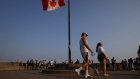 A Canada flag flies as tourists visit Niagara Falls, Ontario, Canada, on Monday, Aug. 9, 2021. Photographer: Cole Burston/Bloomberg