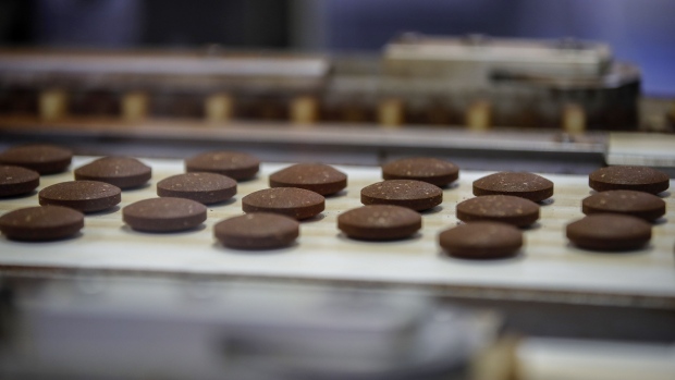 Freshly-pressed pods of ground coffee move along the production line at Nestle SA's Nespresso plant in Avenches, Switzerland, on Thursday, May 20, 2021. Nestle SA sales grew at more than twice the rate analysts expected as the Swiss food giant sold more Nespresso capsules to people working from home and restaurants in Asia stocked up as they started reopening. Photographer: Stefan Wermuth/Bloomberg