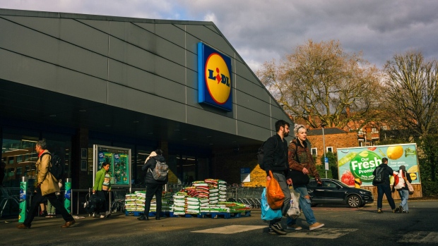 Shoppers leave a Lidl Ltd. supermarket in the Hackney district of London, UK, on Sunday, March 19, 2023. The Office for National Statistics are due to release the latest UK CPI Inflation data on Wednesday.