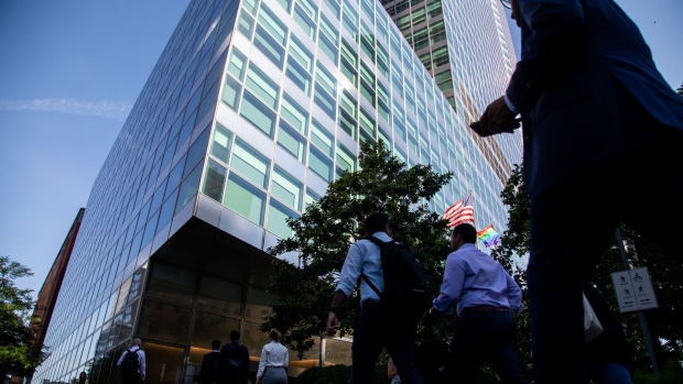 Workers cross the street at Goldman Sachs headquarters in New York, US, on Wednesday, June 15, 2022. The Securities and Exchange Commission is looking into whether some investments for the funds are in breach of ESG metrics promised in marketing materials, one of the people said.