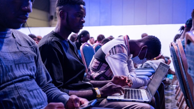 An attendee uses a laptop computer in the audience at the Technext Coinference at the Landmark Event Centre in the Victoria Island district of Lagos, Nigeria, on Monday, Oct. 3, 2022. Nigeria, Africa’s most populous nation, is targeting digital technology as a means to help diversify the economy away from crude oil, taking advantage of an increasingly connected and youthful population. Photographer: Benson Ibeabuchi/Bloomberg