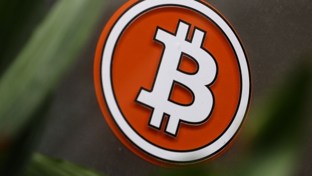 The Bitcoin logo on the window of a cryptocurrency automated teller machine (ATM) kiosk in Antwerp, Belgium, on Monday, June 6, 2022. Bitcoin has been trading around the $30,000 level for weeks now, defying predictions of a potential further decline but also struggling to gain upward momentum as the broader US market has also taken a beating. Photographer: Valeria Mongelli/Bloomberg