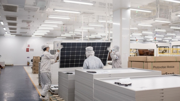 Technicians perform a final inspection of a solar panel prior to packaging at Irex Energy JSC's manufacturing facility in Vung Tau, Vietnam, on Monday, July 15, 2019. After U.S. President Donald Trump slapped higher tariffs on China, production in neighboring Vietnam went into overdrive. Chinese manufacturers, who face a 55% U.S. tariff on their goods, relocated some production to Vietnam, while local businesses saw a jump in orders. In June alone, U.S. imports of solar cells from Vietnam surged 656% from a year ago.