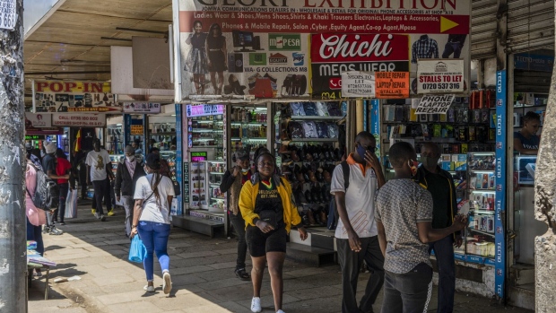 Pedestrians pass by stores on a shopping street in downtown Nairobi, Kenya, on Saturday, Dec. 5, 2020. Kenya is seeking a loan of as much as $2.3 billion from the International Monetary Fund under the lender’s extended fund facility.