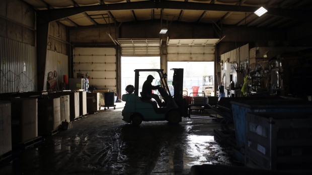A worker drivers a forklift at a metal recycling center in Louisville, Kentucky. Photographer: Luke Sharrett/Bloomberg