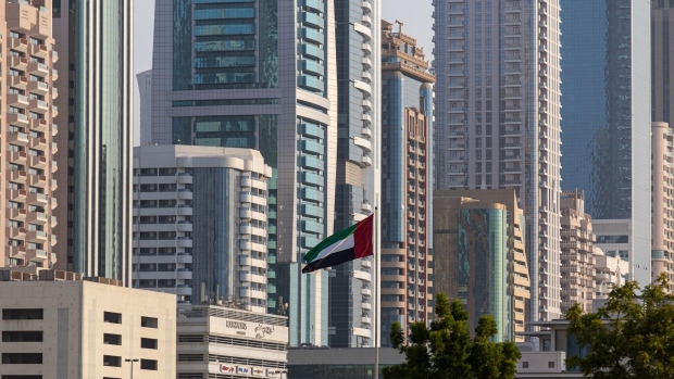 The national flag of the United Arab Emirates flies among commercial and residential properties on the city skyline in Dubai, United Arab Emirates, on Friday, Sept. 16, 2022. Office rents in Dubai are rebounding for the first time in six years, rising faster than in New York or London as global banks and businesses expand into the financial hub known for its love of glitzy construction.