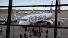 Passengers board a Boeing 737 NG Max, operated by Ryanair Holdings Plc, at a departure gate at Riga International Airport in Riga, Latvia, on Tuesday, March 28, 2023. The summer travel season is shaping up to be a good one for European airlines, prompting Deutsche Bank AG and Barclays Plc to upgrade several carriers that could benefit from rising fares, strong demand and lower jet fuel prices.