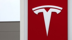 A Tesla Inc. logo on the construction site office at the Tesla Gigafactory building site in Gruenheide, Germany, on Tuesday, May 18, 2021. Tesla Chief Executive Officer Elon Musk reiterated a target for the electric-car maker to start production at its plant in Gruenheide toward the end of this year in an interview with Germanys NTV/RTL media group. Photographer: Liesa Johannssen-Koppitz/Bloomberg