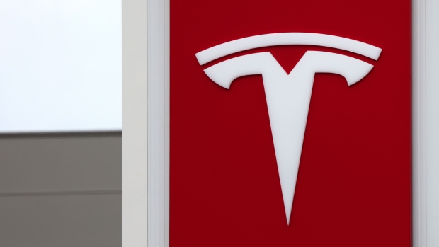 A Tesla Inc. logo on the construction site office at the Tesla Gigafactory building site in Gruenheide, Germany, on Tuesday, May 18, 2021. Tesla Chief Executive Officer Elon Musk reiterated a target for the electric-car maker to start production at its plant in Gruenheide toward the end of this year in an interview with Germanys NTV/RTL media group. Photographer: Liesa Johannssen-Koppitz/Bloomberg