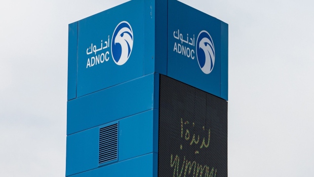 A sign outside an Abu Dhabi National Oil Co. (ADNOC) gas station in the Jumeirah district of Dubai, United Arab Emirates, on Thursday, April 20, 2023. Abu Dhabi’s main energy company ADNOC raised $2.5 billion from the initial public offering of its gas business, pulling off the year’s biggest listing and continuing a trend that saw the Middle East emerge as a bright spot for share sales in 2022. Photographer: Christopher Pike/Bloomberg