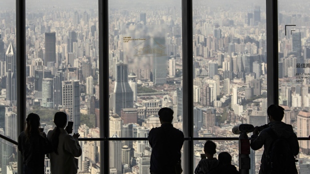 Visitors take in the view from the observation deck at Shanghai Tower in Shanghai, China, on Sunday, April 9, 2023. China's economic recovery is picking up steam after Covid restrictions were abruptly dropped and the property market stabilizes, although the rebound is still fairly patchy and policymakers have no intention yet of scaling back monetary support. Photographer: Qilai Shen/Bloomberg