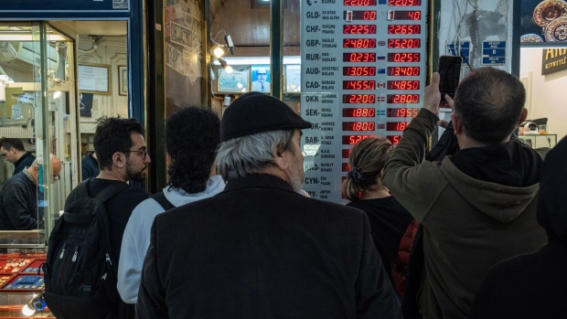 Customers queue to exchange money at a foreign currency exchange bureau in Istanbul, Turkey, on Wednesday, May 3, 2023. Turkey’s inflation slowed below 50% for the first time in over a year, with risks for price stability rising as the country goes to the polls in less than two weeks.