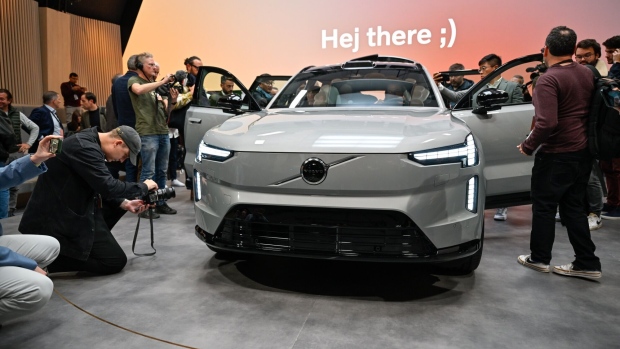 Journalists inspect the EX90, a battery-powered sport utility vehicle, manufactured by Volvo Car AB during its launch event in Stockholm, Sweden, on Wednesday, Nov. 9, 2022. The vehicle, featuring lidar sensors to better see its surroundings, has as much as 600 kilometers (373 miles) of range and succeeds the popular XC90 introduced eight years ago.
