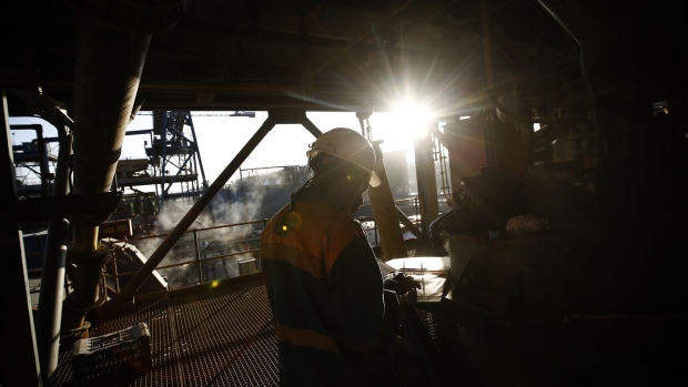A mine worker inspects notes during operations in the refining and processing plant. Photographer: Simon Dawson/Bloomberg