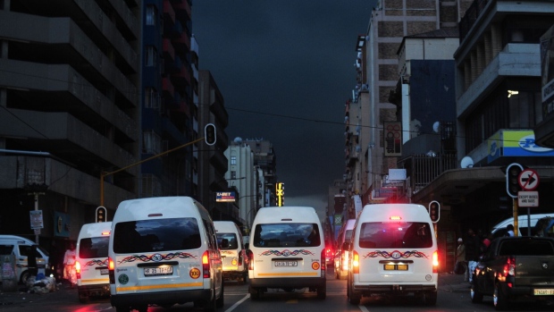 Taxi vans travel along a darkened street without lighting during a loadshedding power outage period, in central Johannesburg, South Africa, on Monday, Feb. 13, 2023. Eskom Holdings SOC Ltd., which supplies most of South Africa’s power from coal-fired plants, has been implementing rolling blackouts since 2008 because it can’t meet demand.
