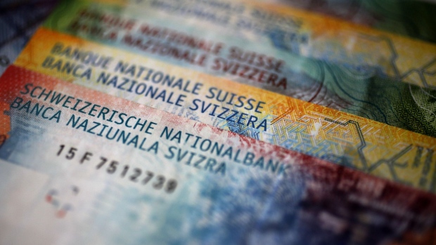 Swiss National Bank (SNB) text sits on Swiss franc banknotes in an arranged photograph in Bern, Switzerland, on Wednesday, June 12, 2019. With the franc having touched a two-year high against the euro, SNB President Thomas Jordan and fellow policy makers are feeling the pressure from risks such as trade tensions, a German industrial slump, Italian politics and Brexit. Photographer: Stefan Wermuth/Bloomberg
