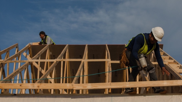Contractors work on the roof of a house under construction in the Stillpointe subdivision in Sumter, South Carolina, U.S., on Tuesday, July 6, 2021. U.S. pending home sales unexpectedly rose in May by the most in nearly a year as low borrowing costs paired with increased listings bolstered demand. Photographer: Micah Green/Bloomberg