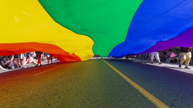 VANCOUVER, BRITISH COLUMBIA - JULY 31: Participants carry a rainbow flag during the Vancouver Pride Parade on July 31, 2022 in Vancouver, British Columbia, Canada. (Photo by Andrew Chin/Getty Images)