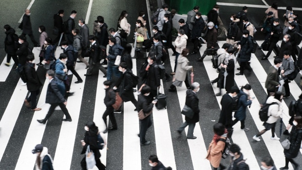 Pedestrians cross a road in Osaka, Japan, on Monday, Feb. 13, 2023. Japan's economy rebounded at a slower pace than expected in the three months through December, in a sign of ongoing weakness that will concern the central bank’s new governor amid intense speculation over possible changes in monetary policy after a decade of massive stimulus.