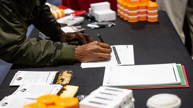A job seeker fills out a form during a Disabled American Veterans (DAV) and RecruitMilitary LLC job fair in Detroit, Michigan, U.S, on Thursday, Oct. 31, 2019. The Department of Labor is scheduled to release initial jobless claims figures on November 7.