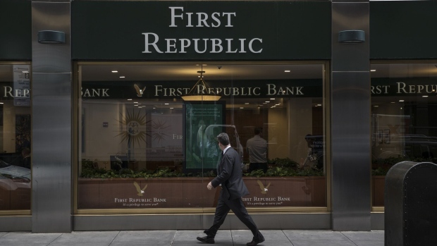 A pedestrian passes in front of a First Republic Bank in New York, U.S., on Tuesday, July 2, 2019. First Republic Bank is scheduled to release earnings figures on July 16.