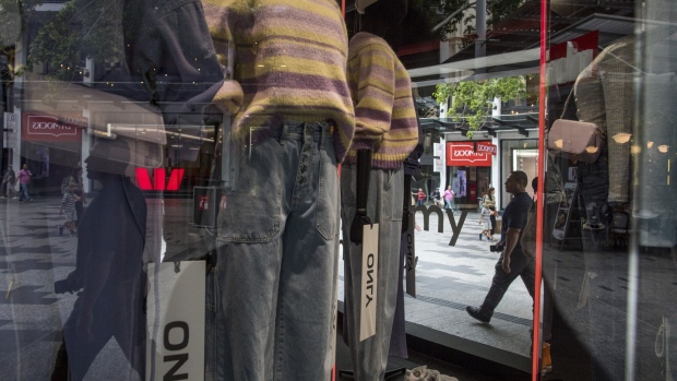A pedestrian is reflected at a shop display at Queen Street Mall in Brisbane, Queensland, Australia, on Monday, April 17, 2023. Australia's chances of sliding into a recession have declined, according to a Bloomberg survey, as the Reserve Bank's decision to pause an 11-month tightening cycle helps improve the economic outlook.