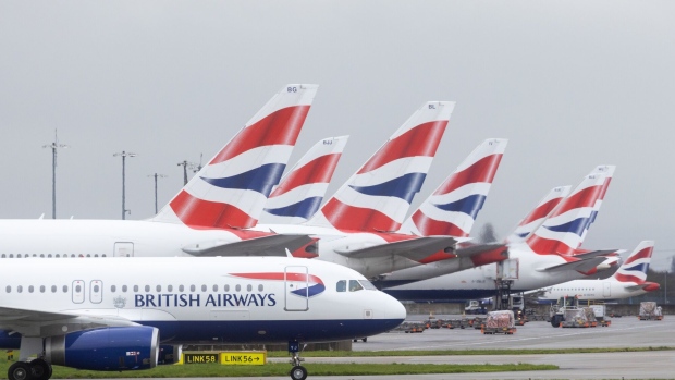 A passenger airplane, operated by British Airways, next to other airplanes on the tarmac at London Heathrow Airport in London, UK, on Friday, March 31, 2023. British Airways is set to scrap 320 flights during the Easter week as security workers strike for 10-days over pay. Photographer: Chris Ratcliffe/Bloomberg