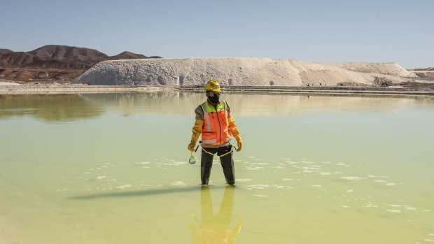 A mine worker takes water samples from a brine pool at the Albemarle Corp. Lithium mine in Calama, Antofagasta region, Chile, on Tuesday, July 20, 2021. Albemarle Corp., the world's biggest producer of lithium, is fast-tracking advanced forms of the metal that could result in better batteries for electric vehicles.