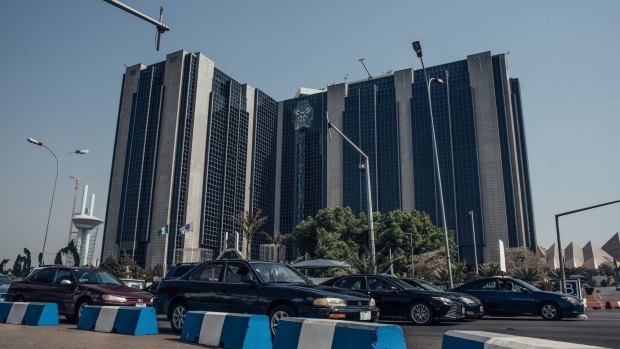 Automobiles drive past the headquarters of the Nigerian central bank in Abuja, Nigeria, on Friday, Jan. 10, 2020. Revenue in Nigeria has fallen short of the government target by at least 45% every year since 2015, and shortfalls have been funded through increased borrowing.