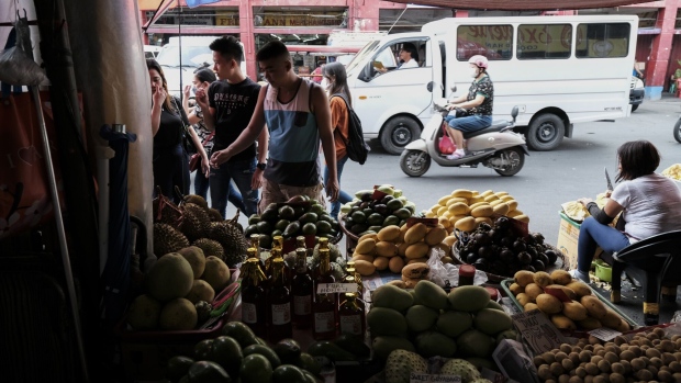 A vendor attends to a customer at a fruit stall in Manila, the Philippines, on March 10, 2023. Philippines’ core inflation bolted to the fastest pace in 24 years, a print that will likely convince policymakers to retain their tightening bias even as the headline measure slowed.