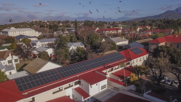 Solar panels, installed by Sun Exchange, on the roof of a school in Cape Town, South Africa, on Wednesday, Aug. 24, 2022. Sun Exchange invites investors to buy solar cells at a project of their choice, where the solar energy customers pay a fee for use, with part of that paid back to investors in either South African rand or Bitcoin. Photographer: Guillem Sartorio/Bloomberg