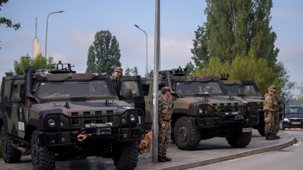 NATO soldiers stand guard in the town of Mitrovica on May 29, 2023, as Serbs protest against the installation of ethnic Albanian mayors, a decision that drew sharp condemnation from the US.  Photographer: Armend Nimani/AFP/Getty Images