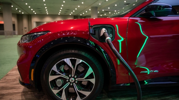 The charging port of a Ford Mustang Mach-E compact sports utility vehicle (SUV) during the 2022 New York International Auto Show (NYIAS) in New York, U.S., on Thursday, April 14, 2022. The NYIAS returns after being cancelled for two years due to the Covid-19 pandemic.