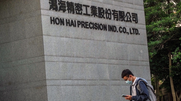 Signage at the Hon Hai Precision Industry Co. headquarters in New Taipei City, Taiwan, on Wednesday, Aug. 10, 2022. Taiwan wants to force Foxconn Technology Group to unwind an $800 million investment in Chinese chipmaker Tsinghua Unigroup, the Financial Times reported, citing unidentified people familiar with the matter. Photographer Lam Yik Fei/Bloomberg Photographer: Lam Yik Fei/Bloomberg