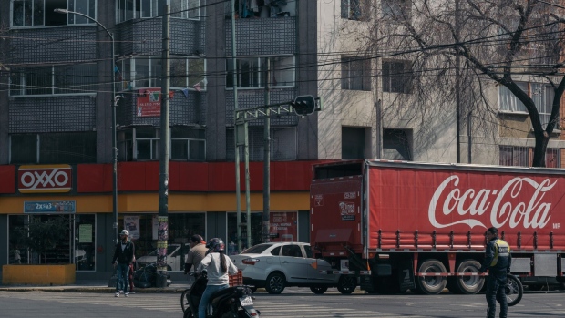 A Coca-Cola delivery truck parked in front of an OXXO convenience store in Mexico City, Mexico, on Wednesday, Jan. 25, 2023. The Latin American soft-drink market (all channels) grew 6% in 2022 to $128 billion. Off-trade channels accounted for 66% of the total vs. 68% in 2021. Photographer: Jeoffrey Guillemard/Bloomberg