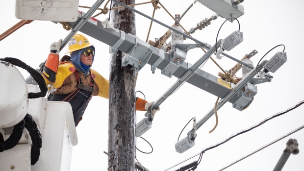 A worker repairs a power line in Austin, Texas, U.S., on Thursday, Feb. 18, 2021. Texas is restricting the flow of natural gas across state lines in an extraordinary move that some are calling a violation of the U.S. Constitution’s commerce clause.