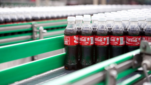 Bottles of Coca-Cola soda move down a conveyor at the Coca-Cola Femsa SAB bottling facility in Toluca, Mexico.