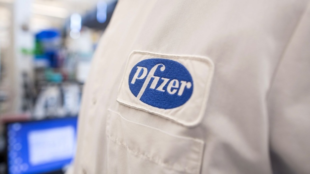 The Pfizer logo on the lab coat of an employee at the company's research and development facility in Cambridge, Massachusetts. Photographer: Scott Eisen/Bloomberg