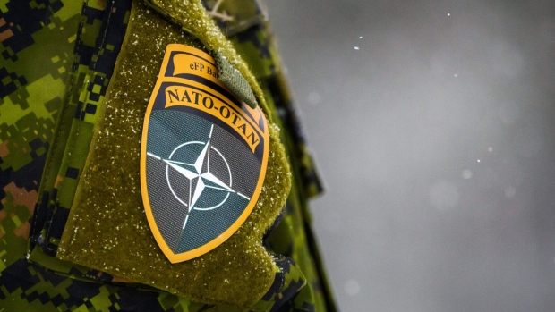 The NATO on a uniform . Photographer: Gints Ivuskans/AFP/Getty Images