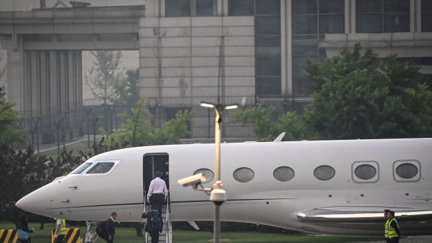 Musk boards his private jet before departing from Beijing Capital International Airport on May 31. Photographer: Jade Gao/AFP/Getty Images