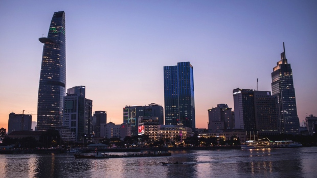 The Bitexco Financial Tower, left, the Saigon Times Square building, center, the Vietcombank Tower, right, and other commercial buildings stand along Saigon River at dusk in Ho Chi Minh city, Vietnam, on Wednesday, Sept. 11, 2019. Vietnam, is the seventh-largest goods exporter to the U.S. Manufacturers are shifting production to places like Vietnam to avoid U.S. tariffs on Chinese imports — one of the more vivid examples of how trade wars are redirecting channels of goods and services. Photographer: Yen Duong/Bloomberg
