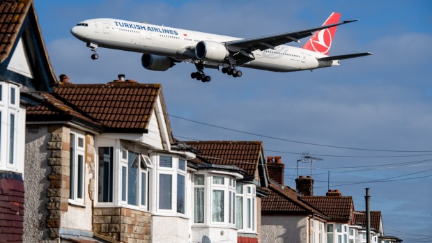 A passenger aircraft, operated by Turk Hava Yollari AO, also known as Turkish Airlines, flies over residential properties as it comes in to land at London Heathrow Airport in London, U.K., on Wednesday, Feb. 23, 2022. London Heathrow airport’s losses from two years of coronavirus disruption swelled to 3.8 billion pounds ($5.2 billion), leaving its finances hanging on a summer travel rebound and the go-ahead from regulators to raise prices.