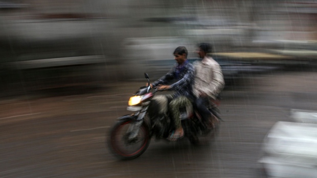 A motorcyclist drives through the monsoon rain in Jalgaon, Maharashtra, in 2021.  Photographer: Dhiraj Singh/Bloomberg