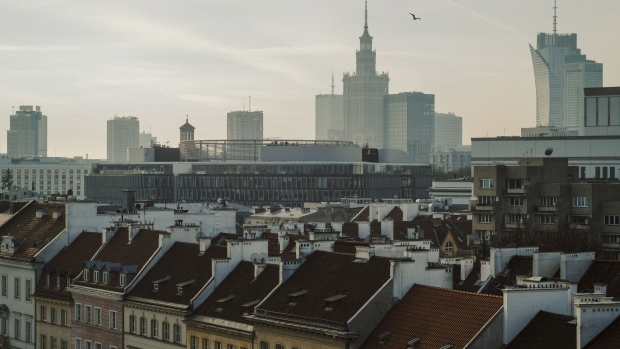The city skyline beyond residential and commercial buildings in the old town in Warsaw, Poland, on Wednesday, Jan. 4, 2023. Poland left borrowing costs unchanged as the threat of an economic recession overshadows concerns over the highest inflation in more than a quarter century. Photographer Damian Lemański/Bloomberg